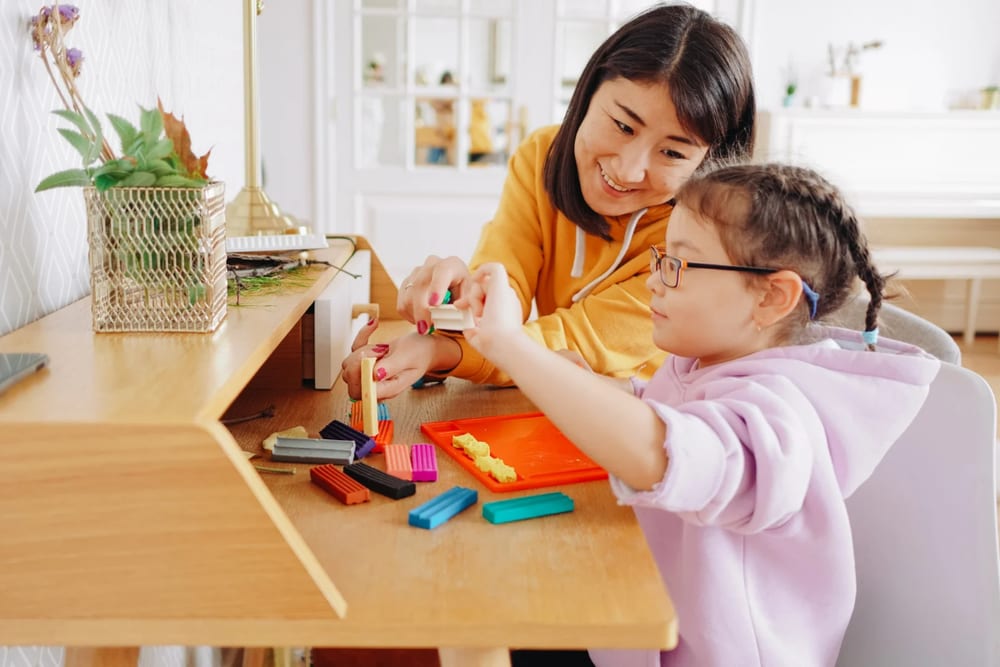 A parent and child learning together with hands-on activities at home